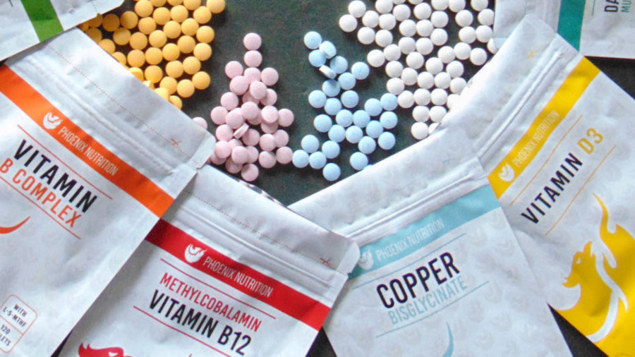 Assorted phoenix nutrition vitamin supplement packages on a dark surface